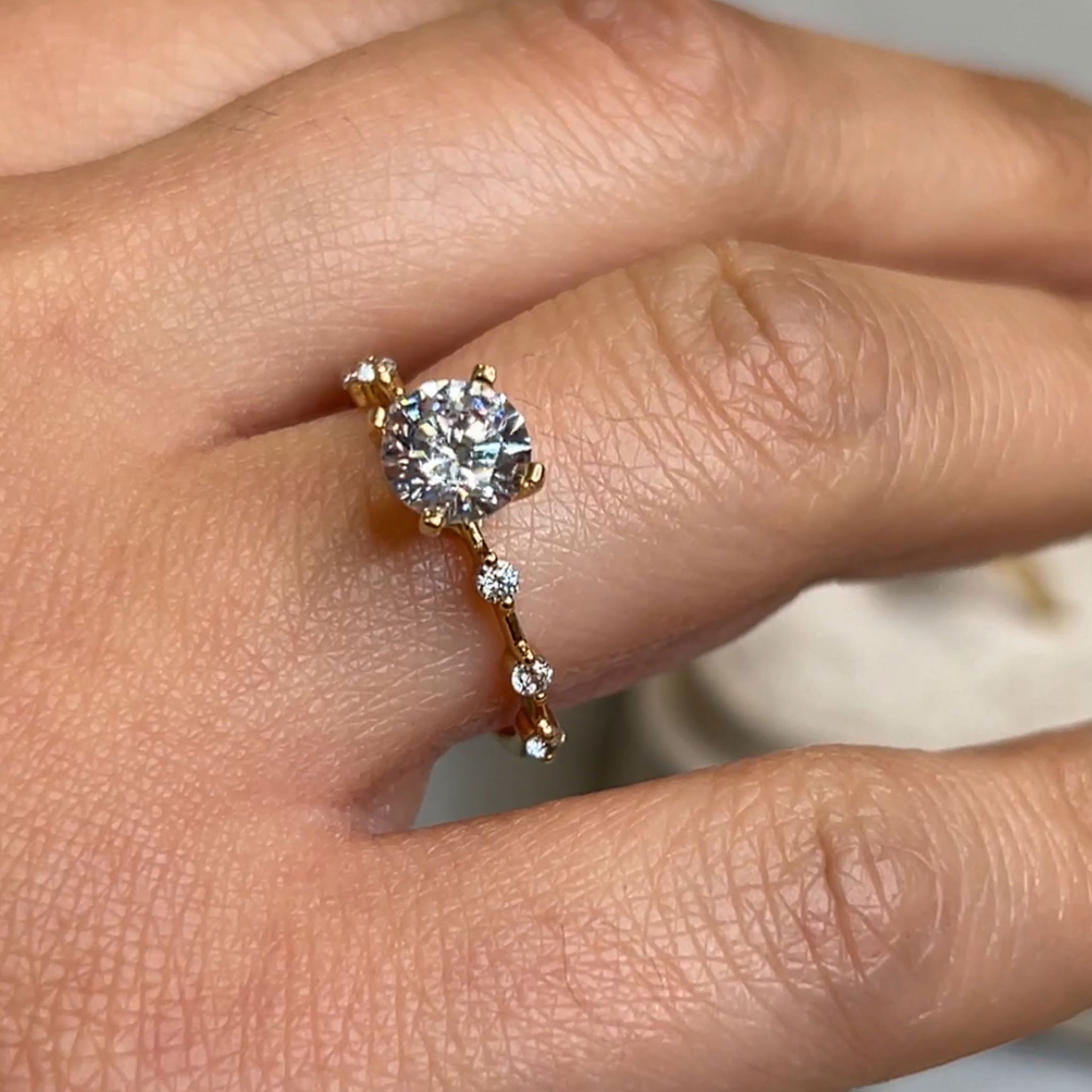 The Portia distance Diamond Engagement Ring with round cut diamond in yellow gold on model hand by Lisa Robin Jewelry