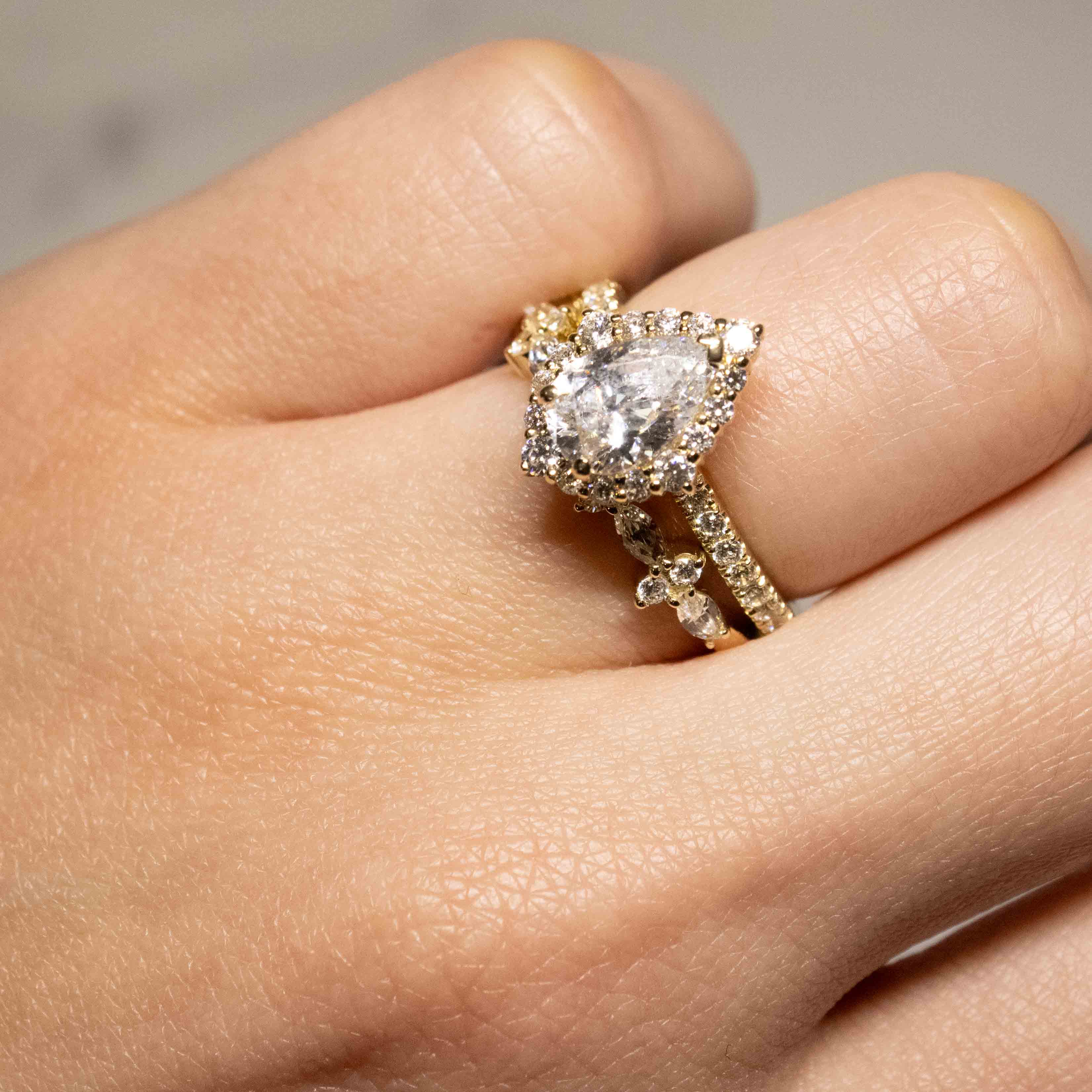 Shown in 1.25 Carat Diamond* The Sierra Aquamarine Pear Halo and Tara Diamond Marquise Wedding Set in yellow gold on model hand by Lisa Robin#color_14k-yellow-gold