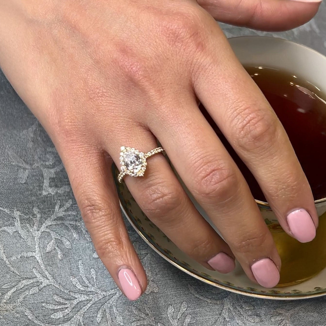 Shown in 1.25 Carat Diamond*The sierra Halo Engagement Ring with pear cut diamond in yellow gold on model hand by Lisa Robin#color_14k-yellow-gold