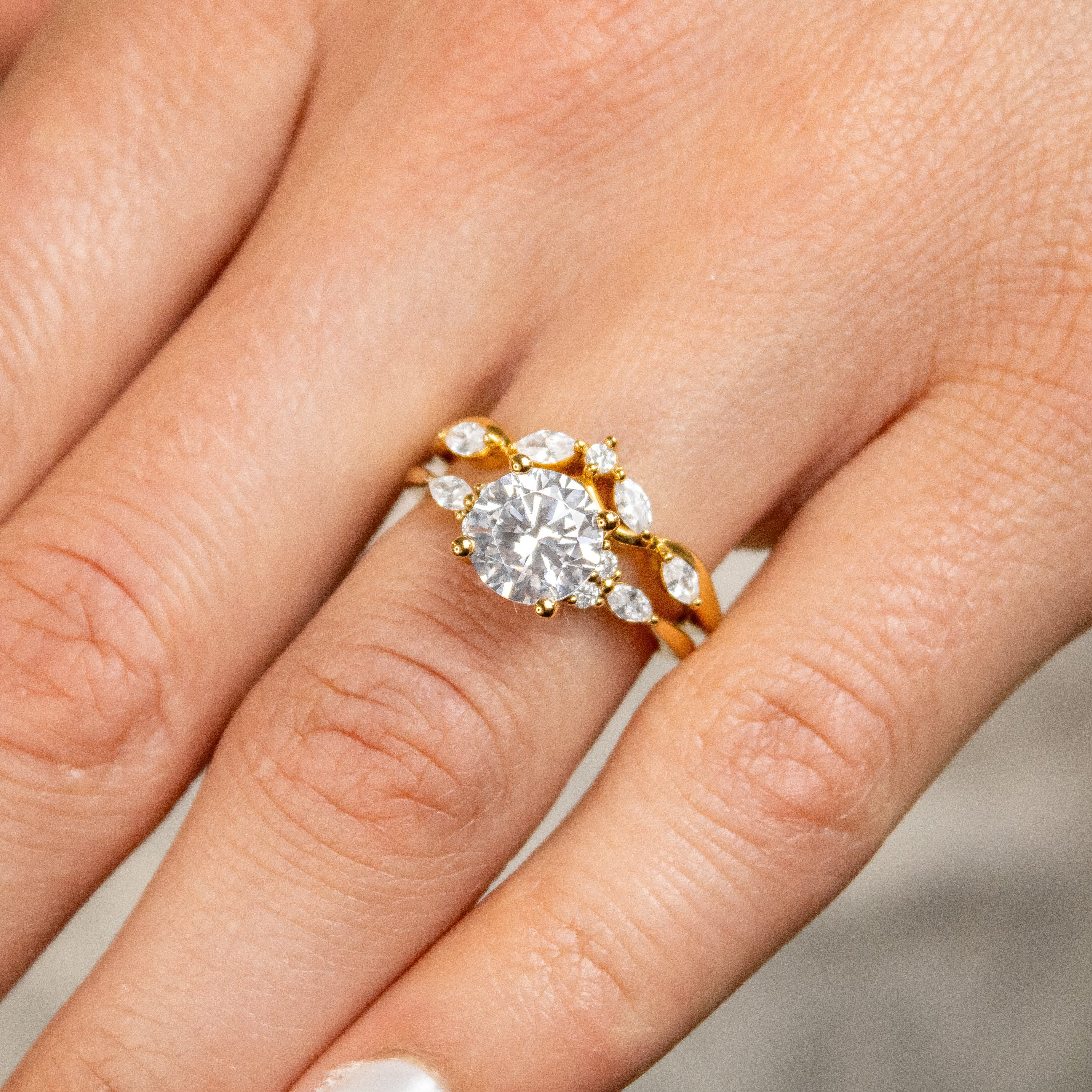 Shown in 2 Carat Diamond*The Sophia Marquise Accented Diamond Engagement Ring with round cut diamond in yellow gold on model hand by Lisa Robin#color_14k-yellow-gold#shape_all