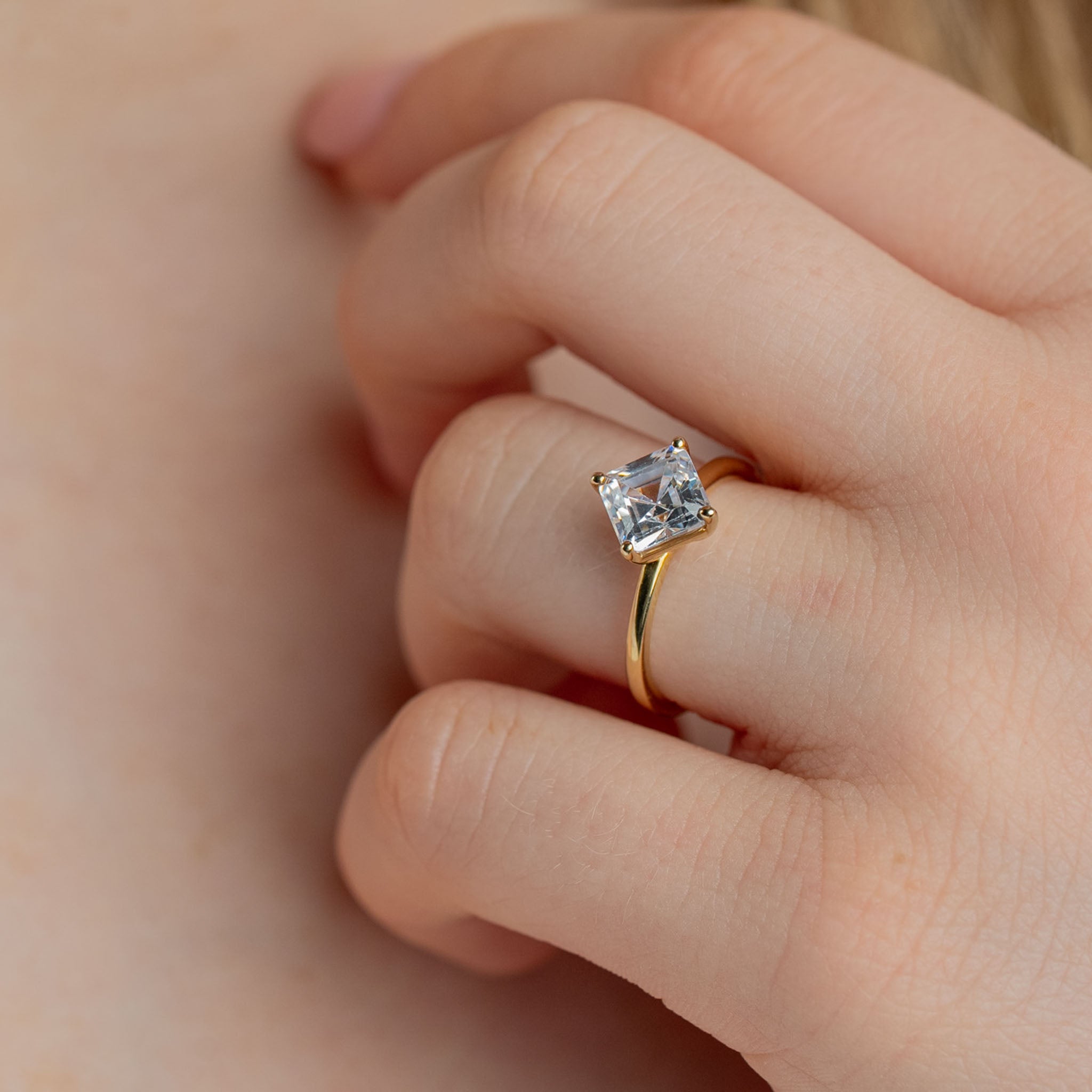 Shown in 2 Carat Diamond*The Stella Compass Set Solitaire Engagement Ring with asscher cut diamond in yellow gold on model hand by Lisa Robin#color_14k-yellow-gold