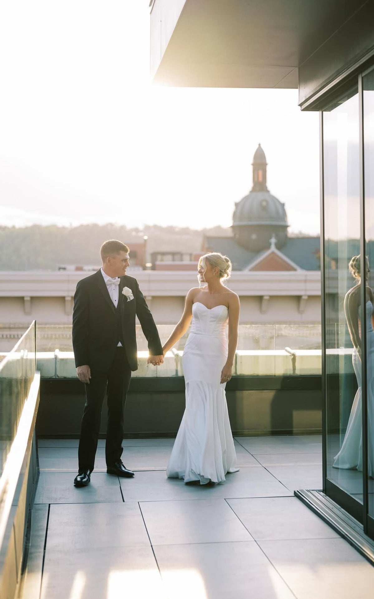 Newly weds standing on rooftop patio overlooking downtown Covington | Lisa Robin