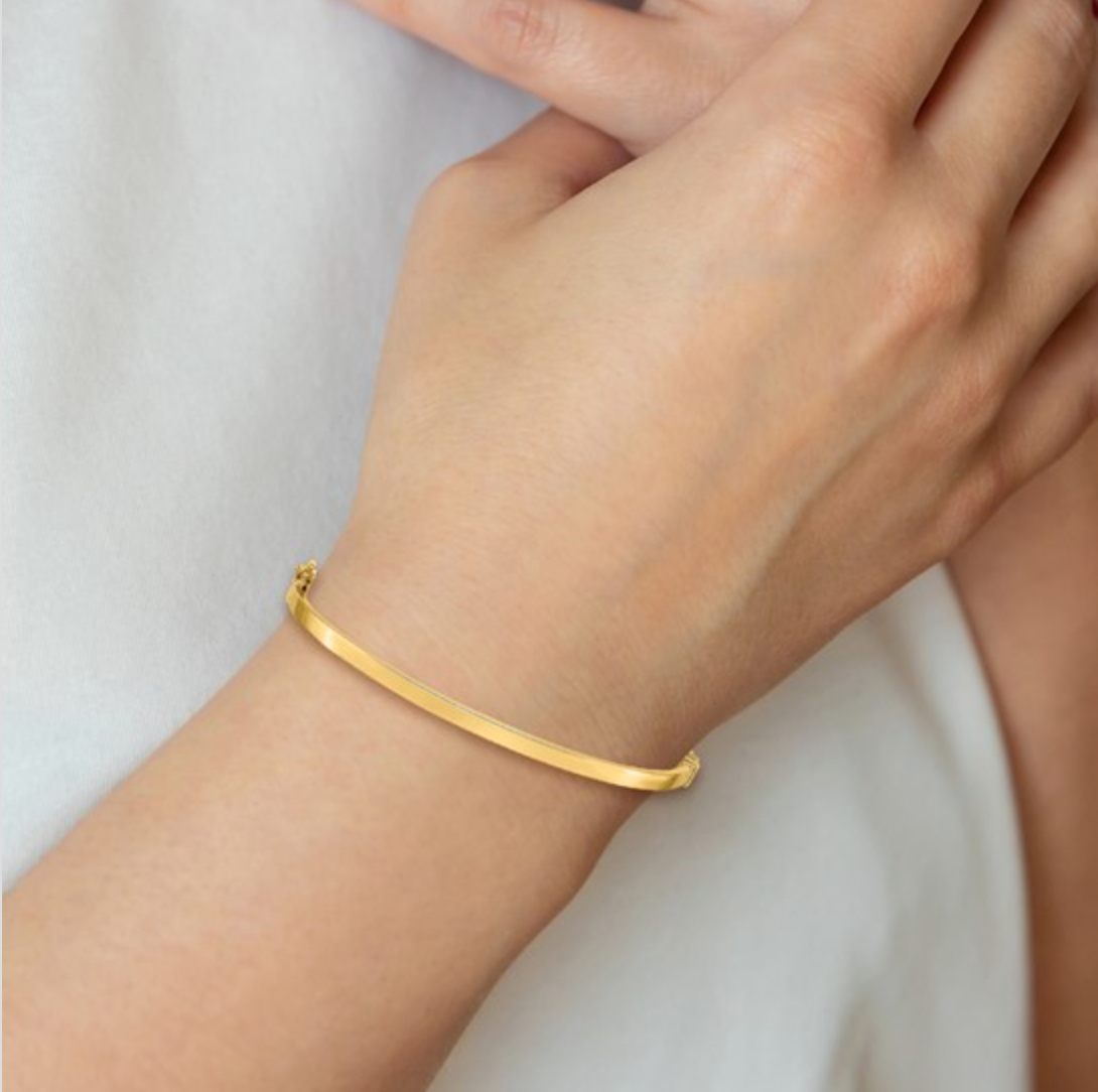 Yellow gold hinged bangle bracelet 3mm wide on model by Lisa Robin