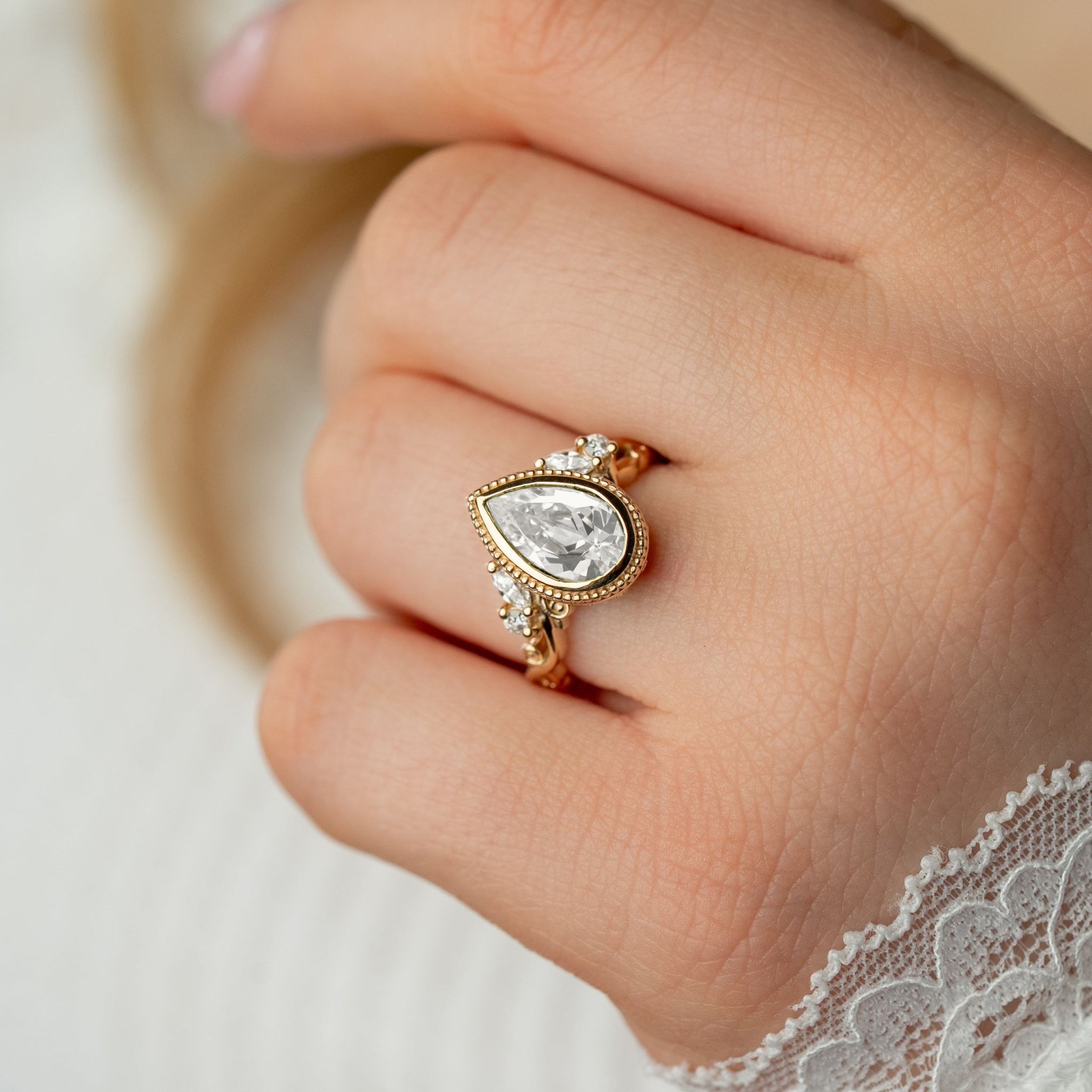 Shown in 2 Carat Diamond*The Fable Symmetry victorian style bezel Engagement Ring with pear cut diamond in yellow gold on model hand by Lisa Robin#color_14k-yellow-gold