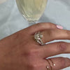 The robin side stone Diamond Engagement Ring with oval cut diamond in yellow gold on model hand by Lisa Robin jewelry