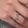 The Remy Twist Engagement Ring with round cut diamond in yellow gold paired with the Quinn twist diamond 14K yellow gold wedding ring on model hand by Lisa Robin Jewelry