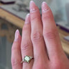 Preferences point toward settings that express romance through detail, proportion, and restraint as shown in the Galaeth cushion cut green lab-grown diamond engagement ring by Lisa Robin Jewelry.