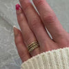 The Ensemble Ring Stack Set comprised of the Dominic Baguette Diamond Wedding Ring in 14K yellow gold with Reese Dome Diamond Wedding Ring in 14K yellow gold and Rene Diamond Wedding Ring in 14K yellow gold on model hand by Lisa Robin Jewelry