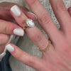 The Ellery Milgrain Bezel Cathedral Engagement Ring with oval cut diamond in yellow gold with Frances Vintage wedding ring in 14K yellow gold on model hand by Lisa Robin Jewelry