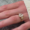 Melayna oval diamond three stone engagement ring paired with Kiran curved gold wedding ring on model's hand by Lisa Robin Jewelry