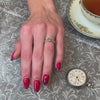 Vivienne oval diamond pave engagement ring styled with Frankie round diamond bezeled wedding ring on model by Lisa Robin