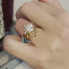 The Katharine Solitaire Diamond Engagement Ring with round cut diamond in yellow gold paired with the Valentina curved diamond 14K white gold wedding ring on model hand by Lisa Robin Jewelry