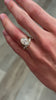 Emery 3.28 carat oval bezel set engagement ring styled with Kendall curved diamond wedding ring on model by Lisa Robin