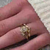 The Evara Twist Diamond Wedding Ring in 14k yellow gold on model hand by Lisa Robin jewelry