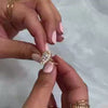 The Hadley Marquise Halo Diamond Engagement Ring with marquise cut diamond in yellow gold on model hand by Lisa Robin jewelry