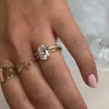 The Casey hidden halo Diamond Engagement Ring with oval cut diamond in yellow gold on model hand by Lisa Robin jewelry
