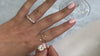 The Leila round diamond twist engagement ring with the Tristan wedding ring on model | Lisa Robin