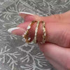 The leaf and vine Diamond wedding Ring in 14K yellow gold on model hand by Lisa Robin jewelry 