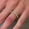 The Samara Half Bezel Oval Diamond Eternity Ring in 14k yellow gold on model hand by Lisa Robin jewelry
