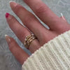 The Ensemble Ring Stack Set comprised of the Evara twist diamond 14K yellow gold wedding ring with Macey Pave Diamond Wedding Ring in 14K yellow gold and Leaf and Vine Diamond Wedding Ring in 14K yellow gold on model hand by Lisa Robin Jewelry