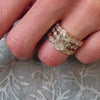 The robin side stone Diamond Engagement Ring with oval cut diamond in yellow gold on model hand by Lisa Robin jewelry