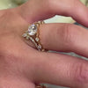 The Portia distance Diamond Engagement Ring with oval cut diamond in yellow gold and The Halee Chevron Diamond Wedding Ring in 14K yellow gold on model hand by Lisa Robin Jewelry